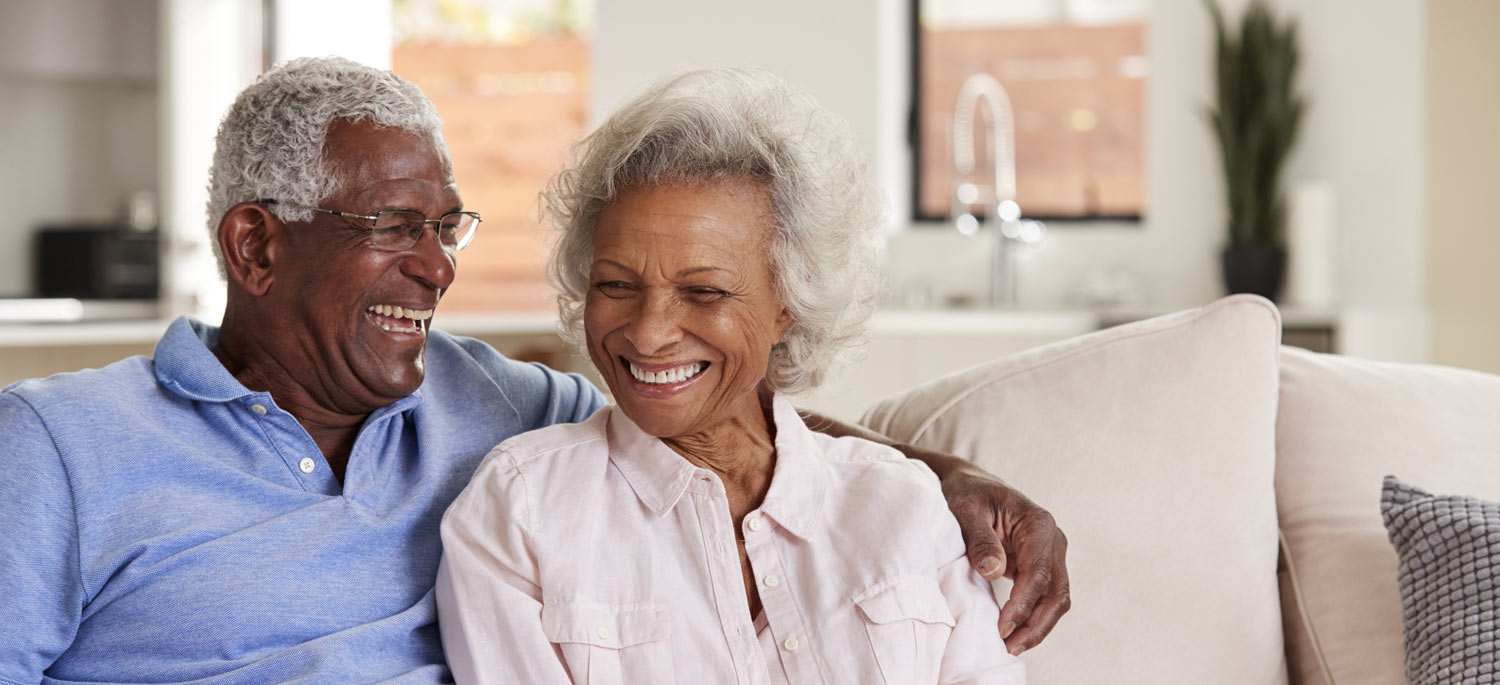 happy senior couple on couch