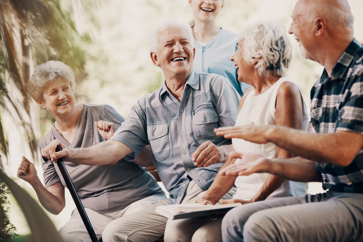 Seniors Sitting Outside Laughing at a VRS Retirement Community
